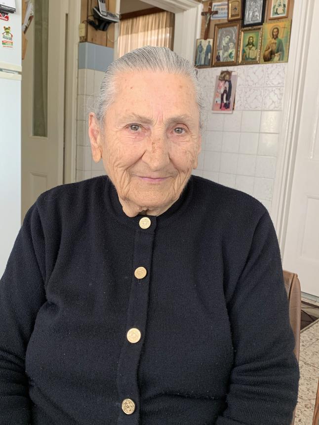 An older person wearing a cardigan