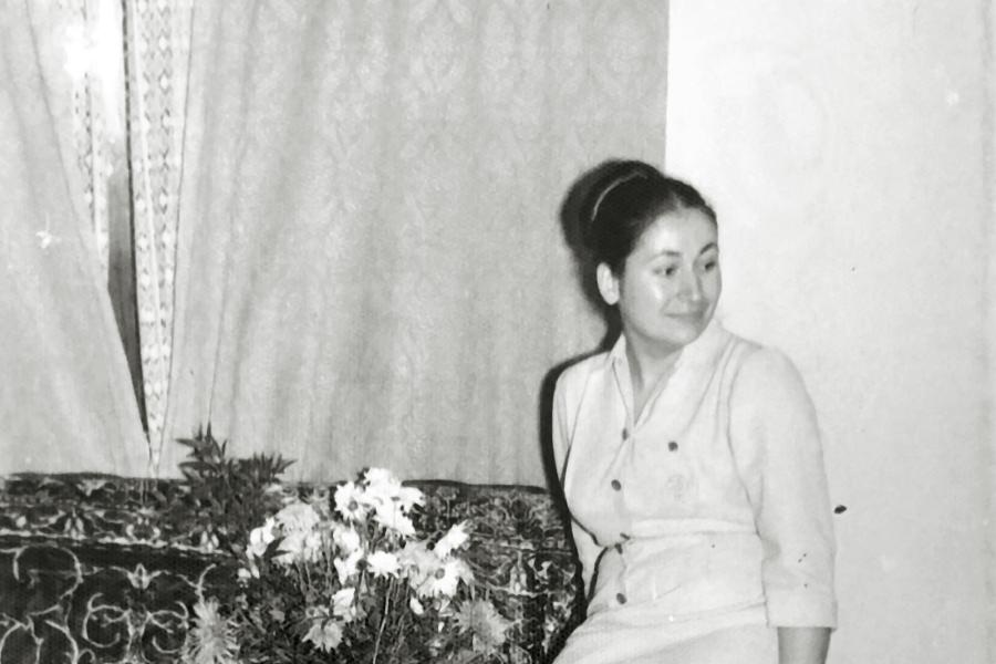 A person is sitting on the arm of a lounge