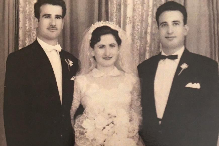 Three people in wedding attire