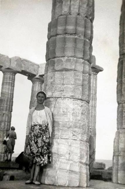 Panagiota Krili standing next to an old column, Sounio, Greece. 1958