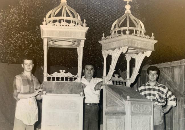 Emmanuel Dimitriades with his father Christos (centre) and brother George  (left) after completing pieces of church furniture, standing outside their workshop in Kensington c.1962