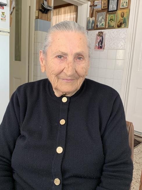 An older person wearing a cardigan
