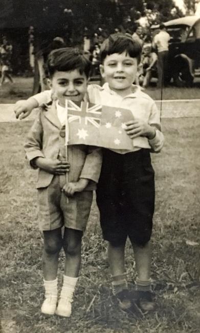 Two happy children holding an Australian flag