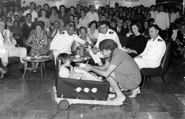 A child is entertained by a person in a costume