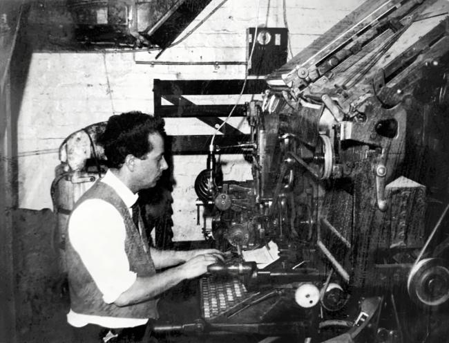 A person is working at a large machine