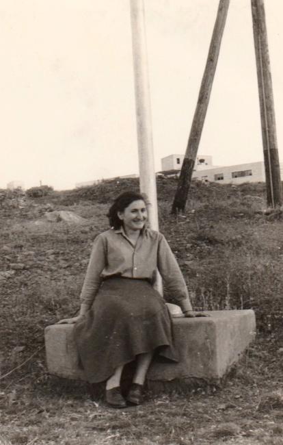 A person sitting on a concrete block