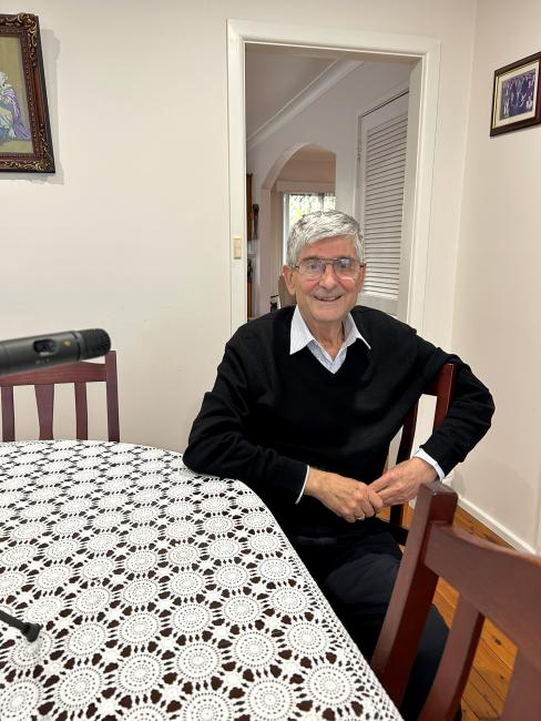 A older person sitting at a table