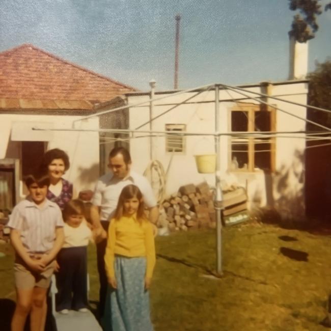 A family standing in a backyard