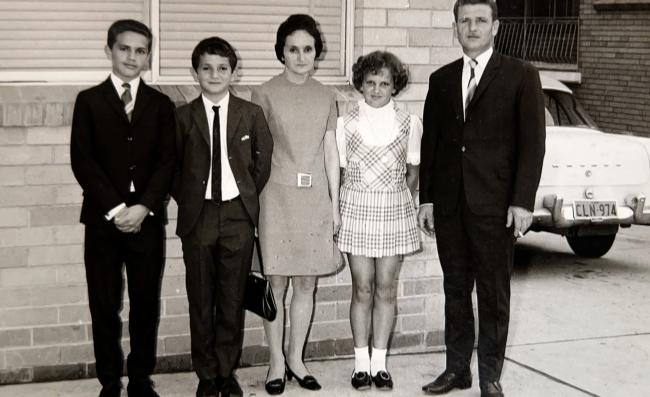 A family standing in front of a house