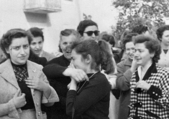 A group of people around one crying person